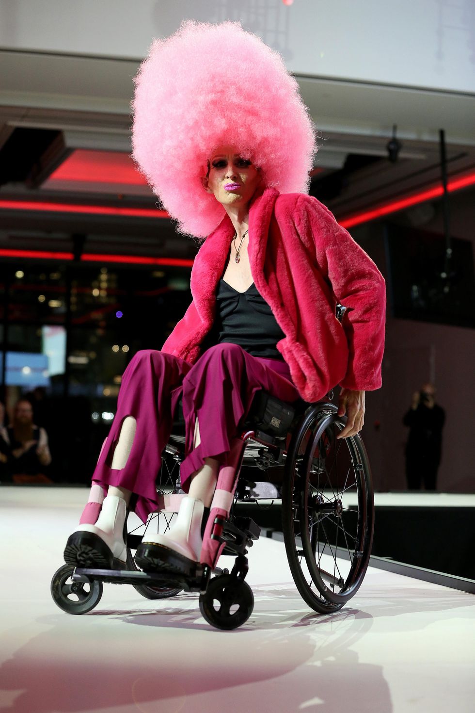 A Disabled LGBTQ+ model showcases adaptive design at a \u200bRunway of Dreams Foundation fashion show.