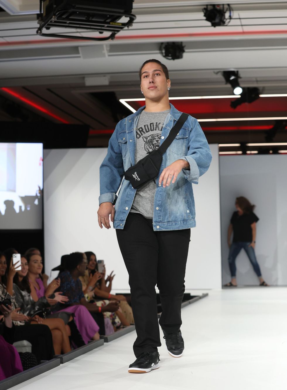 A Disabled LGBTQ+ model showcases adaptive design at a \u200bRunway of Dreams Foundation fashion show.