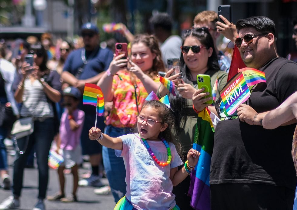 A family watch the Los Angeles Pride parade