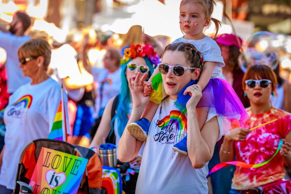 A family wearing colorful costumes at Portland Oregon Pride