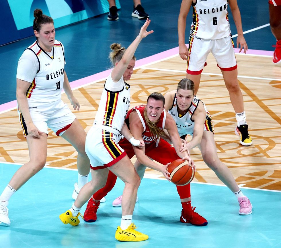 BOIC-COIB's team leader Gert Van Looy and USA's Kaleah Copper pictured in action during a basketball game between Team USA and Belgian national team The Belgian Cats, in the group stage of the women's tournament at the Paris 2024 Olympic Games, on Thursday 01 August 2024 in Paris, France. The Games of the XXXIII Olympiad are taking place in Paris from 26 July to 11 August. The Belgian delegation counts 165 athletes competing in 21 sports. BELGA PHOTO VIRGINIE LEFOUR (Photo by VIRGINIE LEFOUR / BELGA MAG / Belga via AFP) (Photo by VIRGINIE LEFOUR/BELGA MAG/AFP via Getty Images)