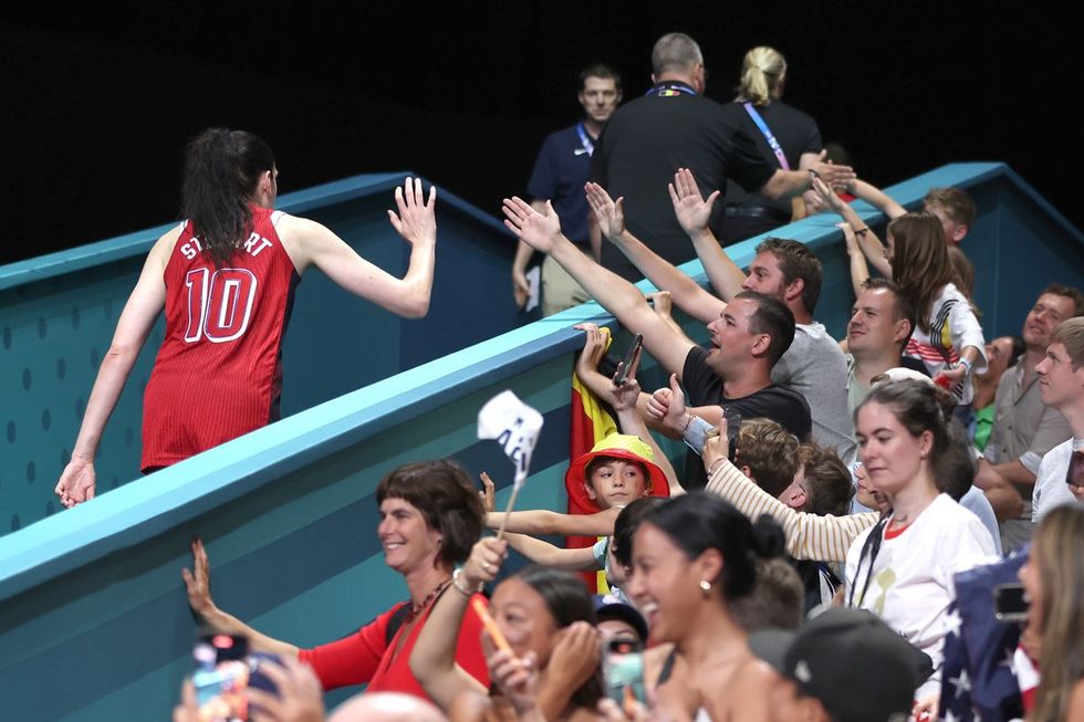 LILLE, FRANCE - AUGUST 01: Breanna Stewart #10 of Team United States high fives fans after a Women's Basketball Group Phase - Group C game between the United States and Belgium on day six of the Olympic Games Paris 2024 at Stade Pierre Mauroy on August 01, 2024 in Lille, France. (Photo by Gregory Shamus/Getty Images)