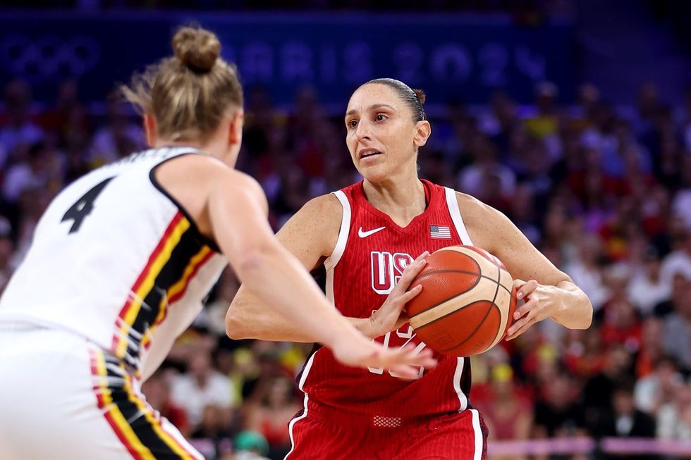 LILLE, FRANCE - AUGUST 01: Diana Taurasi #12 of Team United States looks to pass while defended by Elise Ramette #4 of Team Belgium during a Women's Basketball Group Phase - Group C game between the United States and Belgium on day six of the Olympic Games Paris 2024 at Stade Pierre Mauroy on August 01, 2024 in Lille, France. (Photo by Gregory Shamus/Getty Images)