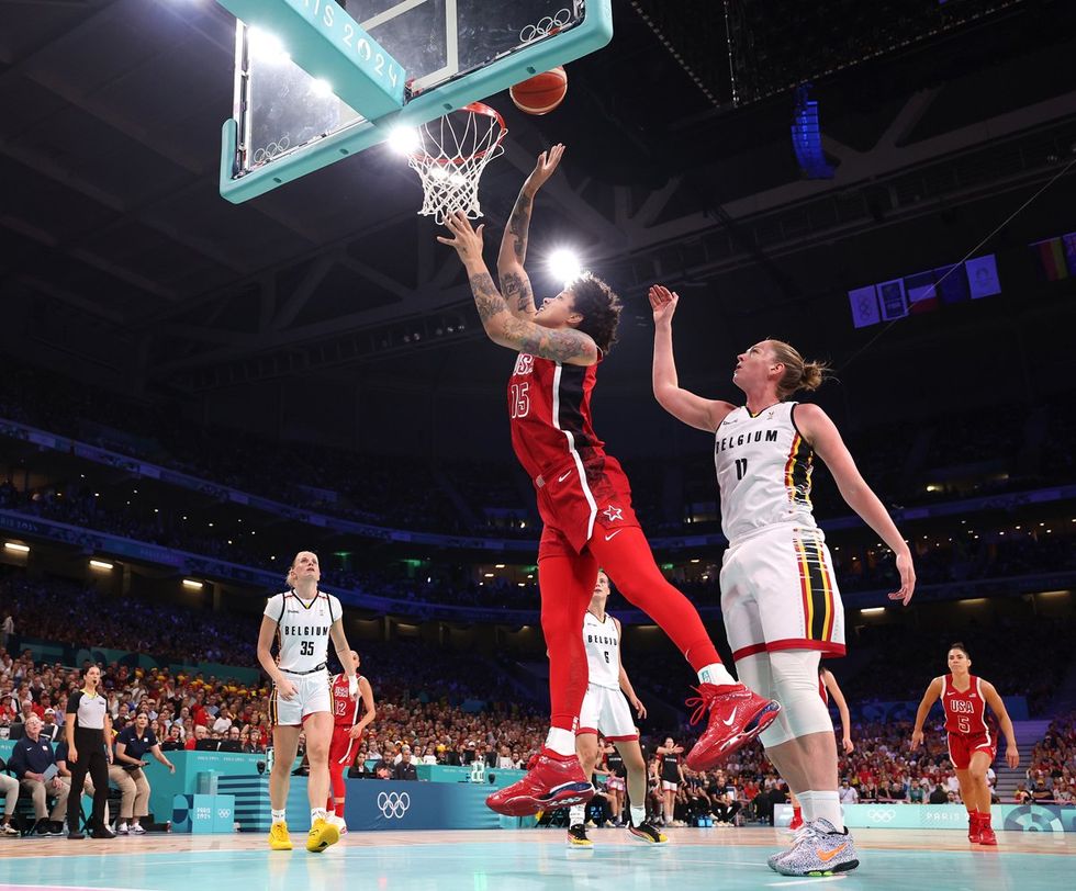 LILLE, FRANCE - AUGUST 01: (EDITORS NOTE: Image was captured using a remote camera) Brittney Griner #15 of Team United States shoots over Emma Meesseman #11 of Team Belgium during a Women's Basketball Group Phase - Group C game between the United States and Belgium on day six of the Olympic Games Paris 2024 at Stade Pierre Mauroy on August 01, 2024 in Lille, France. (Photo by Gregory Shamus/Getty Images)