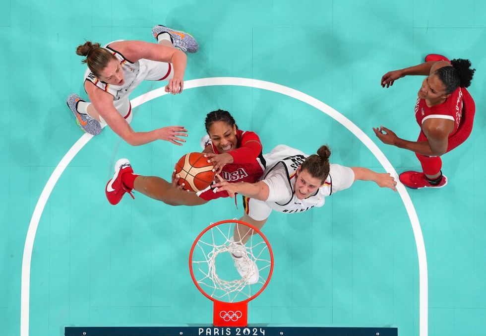 LILLE, FRANCE - AUGUST 01: (EDITORS NOTE: Image was captured using a remote camera positioned above the field of play) A'Ja Wilson #9 of Team United States and Kyara Linskens #13 of Team Belgium grab a rebound during a Women's Basketball Group Phase - Group C game between the United States and Belgium on day six of the Olympic Games Paris 2024 at Stade Pierre Mauroy on August 01, 2024 in Lille, France. (Photo by Pool/Getty Images)