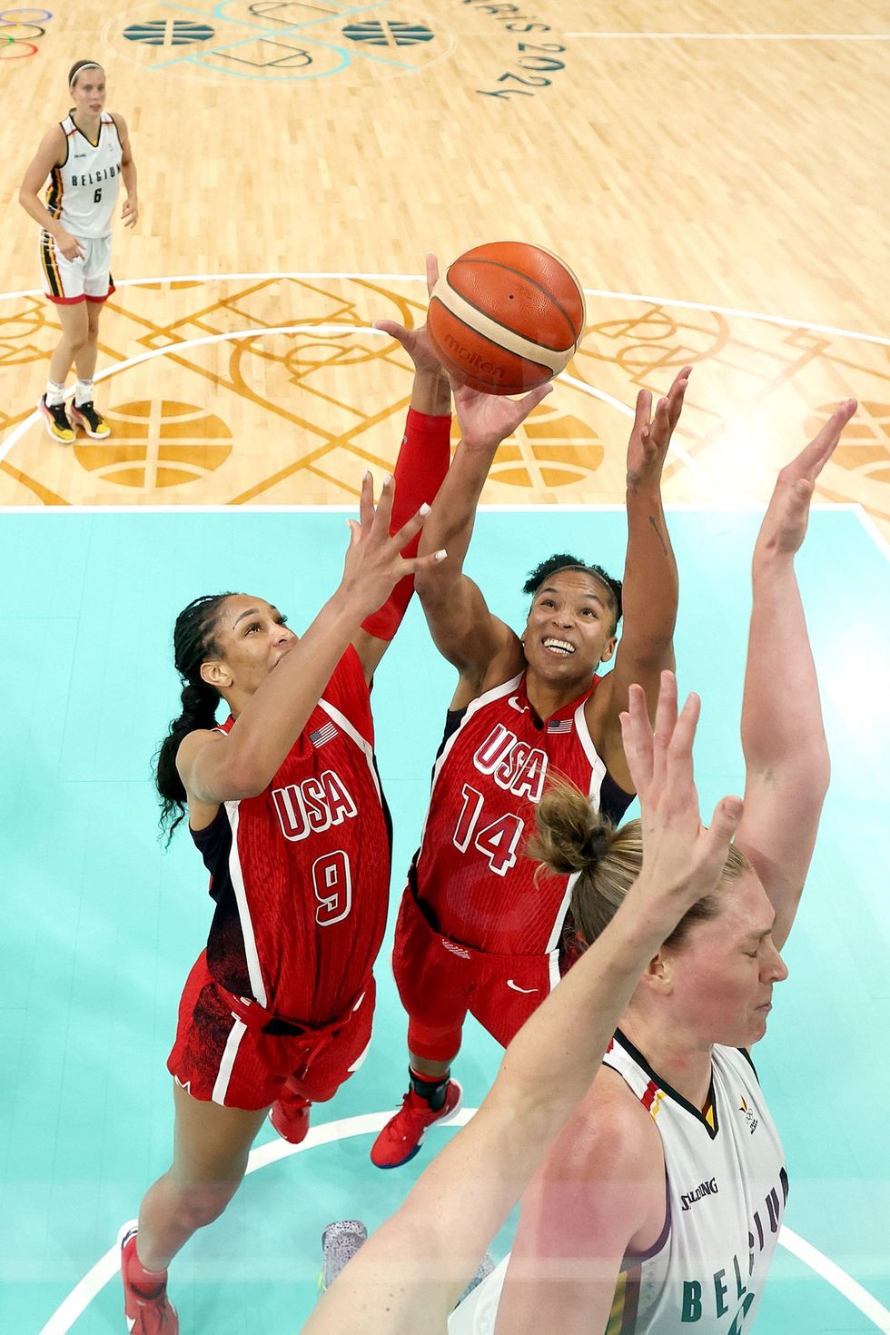 LILLE, FRANCE - AUGUST 01: (EDITORS NOTE: Image was captured using a remote camera positioned above the field of play) A'Ja Wilson #9 and Alyssa Thomas #14 of Team United States attempt to grab a rebound during a Women's Basketball Group Phase - Group C game between the United States and Belgium on day six of the Olympic Games Paris 2024 at Stade Pierre Mauroy on August 01, 2024 in Lille, France. (Photo by Gregory Shamus/Getty Images)