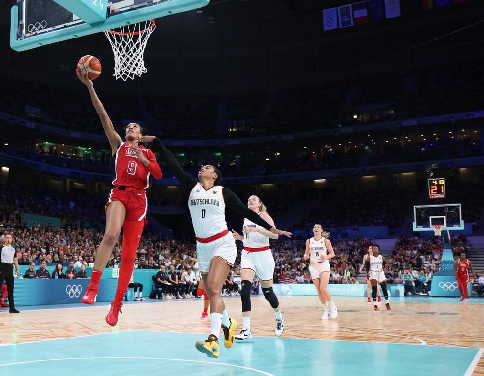 LILLE, FRANCE - AUGUST 04: A'Ja Wilson #9 of Team United States goes up for a basket past Satou Sabally #0 of Team Germany during a Women's basketball Group Phase - Group C game between the United States and Germany on day nine of the Olympic Games Paris 2024 at Stade Pierre Mauroy on August 04, 2024 in Lille, France. (Photo by Gregory Shamus/Getty Images)