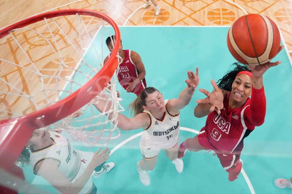 LILLE, FRANCE - AUGUST 04: (EDITORS NOTE: Image was captured using a remote camera positioned above the field of play) A'Ja Wilson #9 of Team United States shoots over Luisa Geiselsoder #15 of Team Germany during a Women's basketball Group Phase - Group C game between the United States and Germany on day nine of the Olympic Games Paris 2024 at Stade Pierre Mauroy on August 04, 2024 in Lille, France. (Photo by Pool/Getty Images)