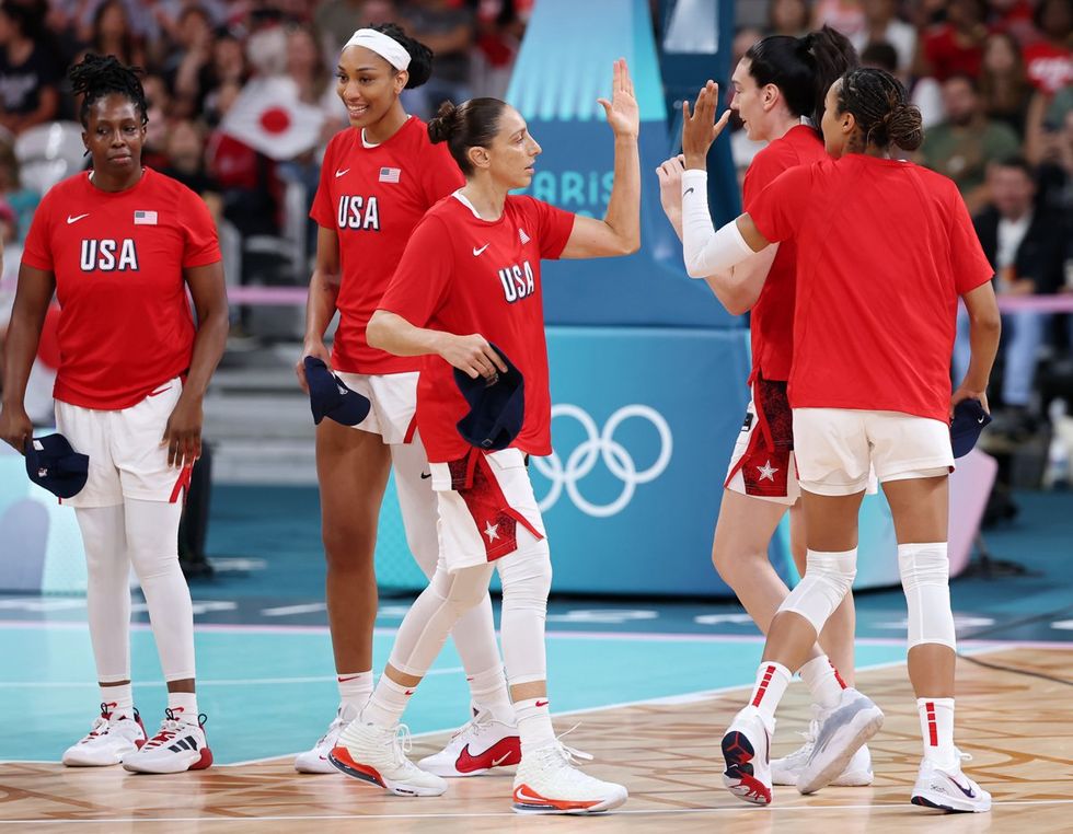 LILLE, FRANCE - JULY 29: Diana Taurasi #12 of Team United States high fives teammates before the Women's Group Phase - Group B game between Japan and United States on day three of the Olympic Games Paris 2024 at Stade Pierre Mauroy on July 29, 2024 in Lille, France. (Photo by Gregory Shamus/Getty Images)