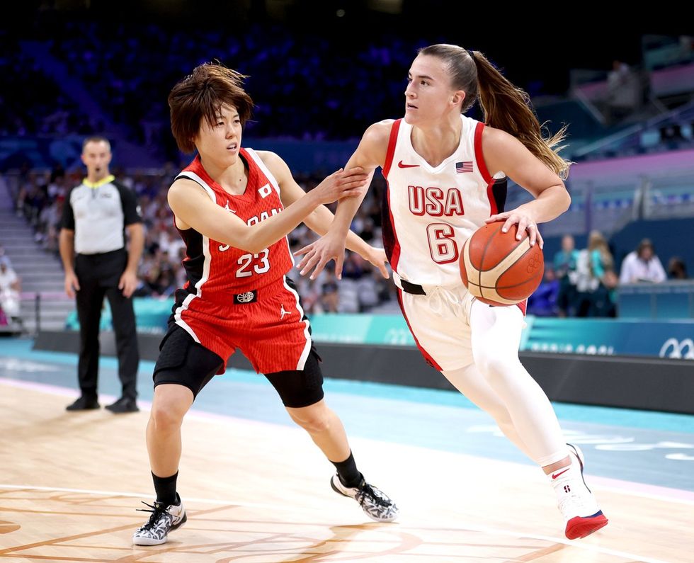 LILLE, FRANCE - JULY 29: Sabrina Ionescu #6 of Team United States drives past Mai Yamamoto #23 of Team Japan during the Women's Group Phase - Group C game between Japan and United States on day three of the Olympic Games Paris 2024 at Stade Pierre Mauroy on July 29, 2024 in Lille, France. (Photo by Gregory Shamus/Getty Images)