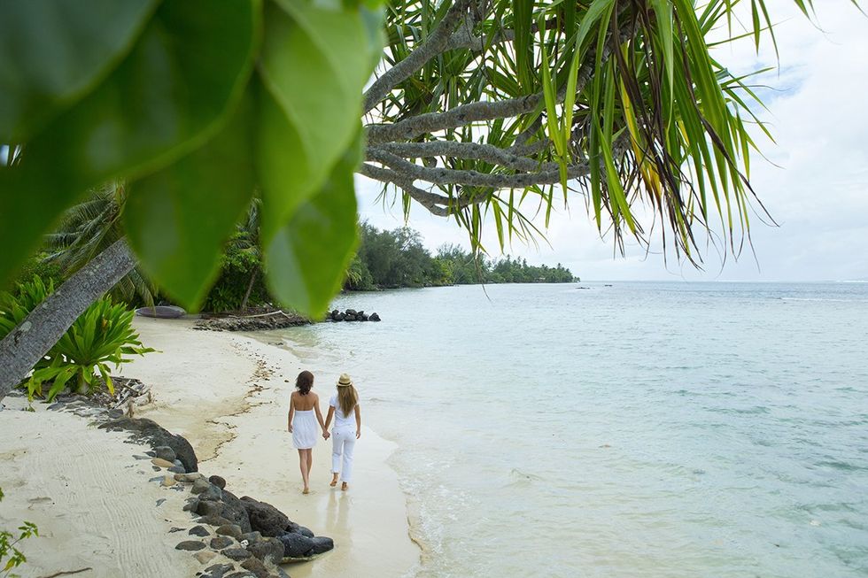 Lovers strolling on the island of Mo\u2019orea in French Polynesia