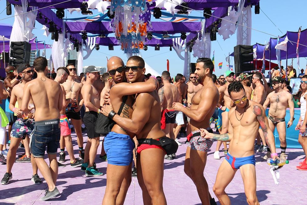 Miami, Florida. Happy (and hot) gay men share a hug at the Winter Party Festival in Miami Beach, Florida