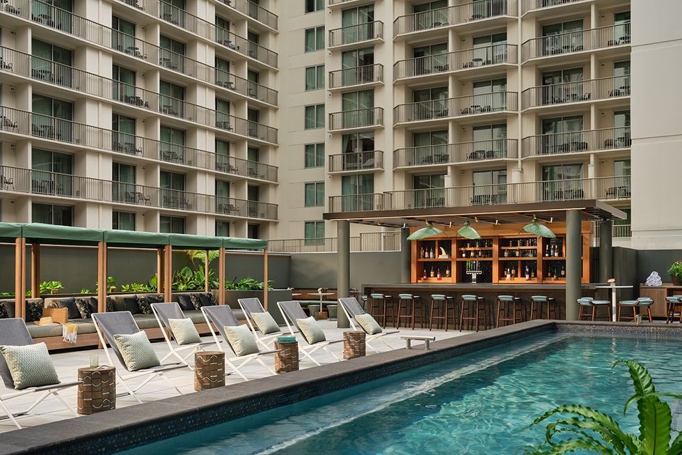 The chic Backyard Pool and Bar at the Romer House Waikiki. Oahu\u2019s first adults-only hotel in the heart of Honolulu is the perfect Hawaiian getaway \u2013 Experience an unforgettable fusion of island charm and city energy at the Romer House Waikiki.