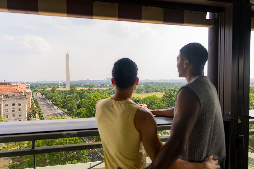 Washington, D.C. Gears Up for WorldPride 2025 - \u200bBarry Hoy and Teraj view the Washington Monument from VUE Rooftop DC restaurant